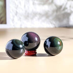 4cm,Natural Rainbow Eye Obsidian Crystal Ball – Polished Sphere with Raw Stone Base, Volcanic Glass Feng Shui Ornament, Healing Crystal Craft for Home Office Desk Decor