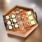 Ghasitaram Gifts Rakhi Gifts for Brothers Hexagon Tray of Assorted Bites, Laddoos, Roli Chawal Container and Bhaiya Bhabhi Rakhis