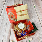 LOVENSPIRE Rakhi Gift Hamper for Brother 2PC Ganesha Rakhi with Candle Holder Ceramic Key Chain Roli Chawal Rakshabandhan Card Chocolates with Premium Brocade Gift Box - Bracelet for Bhai Bhabhi