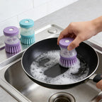 2 Pack Soap Dispensing Dish Brush, Kitchen Scrub Brush with Liquid Dispenser, Non-Scratch Palm Scrubber for Pots Pans Sinks, Durable Bristles Cleaning Tool, Green & Purple (Colors May Vary)