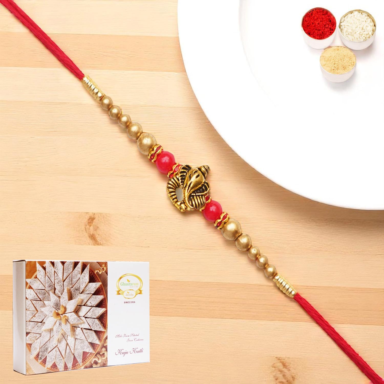 Ghasitaram Gifts Jaiccha Rakhis for Brother Rakhis Online - Y-26 Ganesha divine Rakhi with 200 gms of Kaju katli