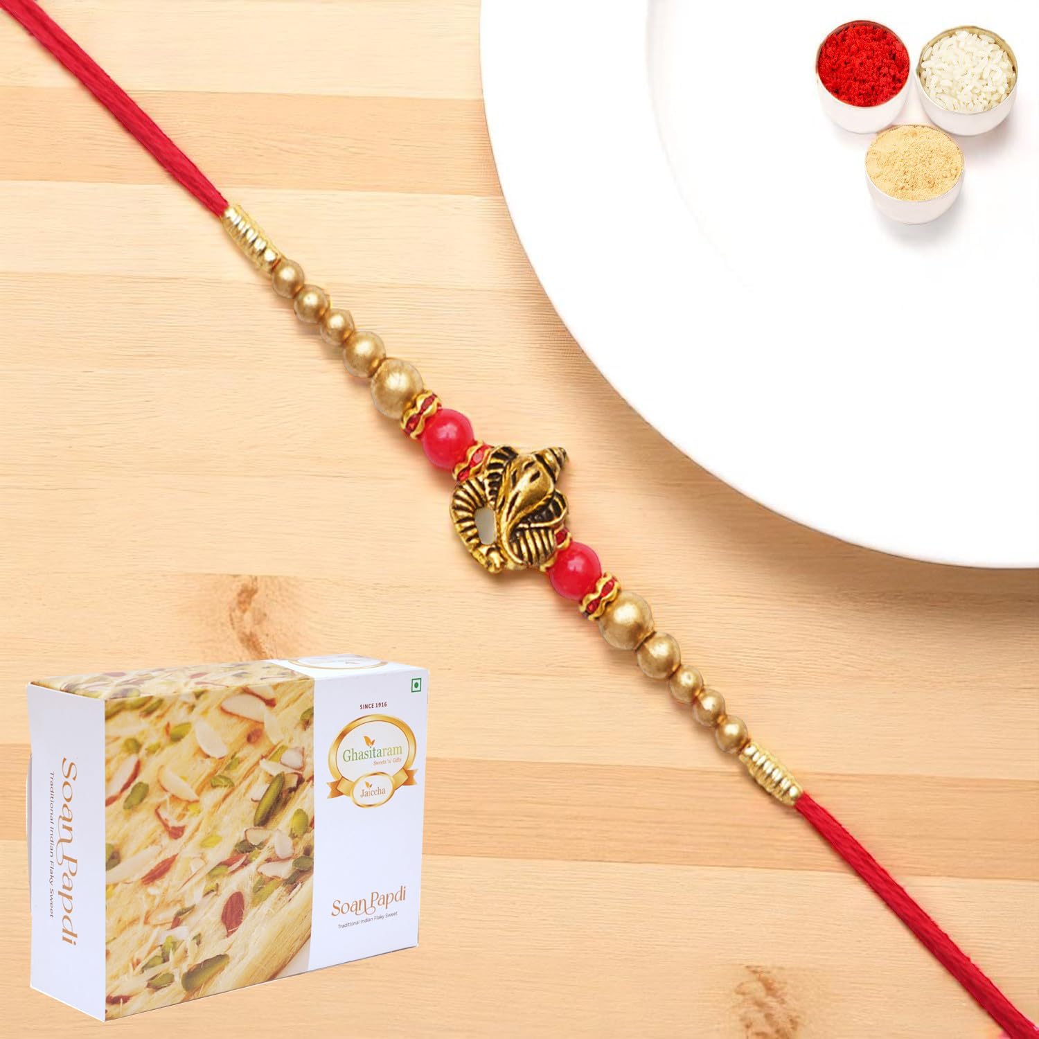 Ghasitaram Gifts Jaiccha Rakhis for Brother Rakhis Online - Y-26 Ganesha divine Rakhi with 200 gms of Soan Papdi