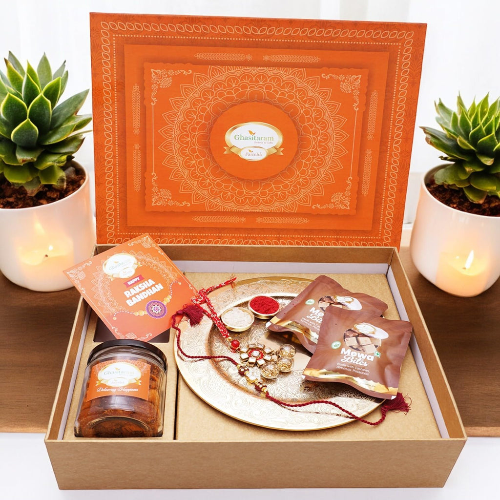 Ghasitaram Gifts Jaiccha Rakhi Gifts for Brothers Orange Hamper Box with Gold Pooja Thali, Bhaiya Bhabhi Rakhis, Card, Mewa Bites Pouches and Mixed Dryfruit Jar