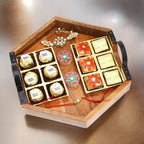 Ghasitaram Gifts Rakhi Gifts for Brothers Hexagon Tray of Assorted Bites, Laddoos, Roli Chawal Container and Bhaiya Bhabhi Rakhis