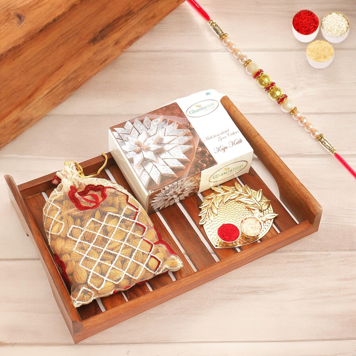 Ghasitaram Gifts Rakhi Gifts for Brothers Wooden Serving Tray with Kaju Katli, Almonds and Pooja Thali with Pearl Rakhi