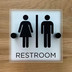 Restroom sign, matte acrylic with stainless steel mounting hardware (7" x 7" man/woman with word "RESTROOM", NO braille)
