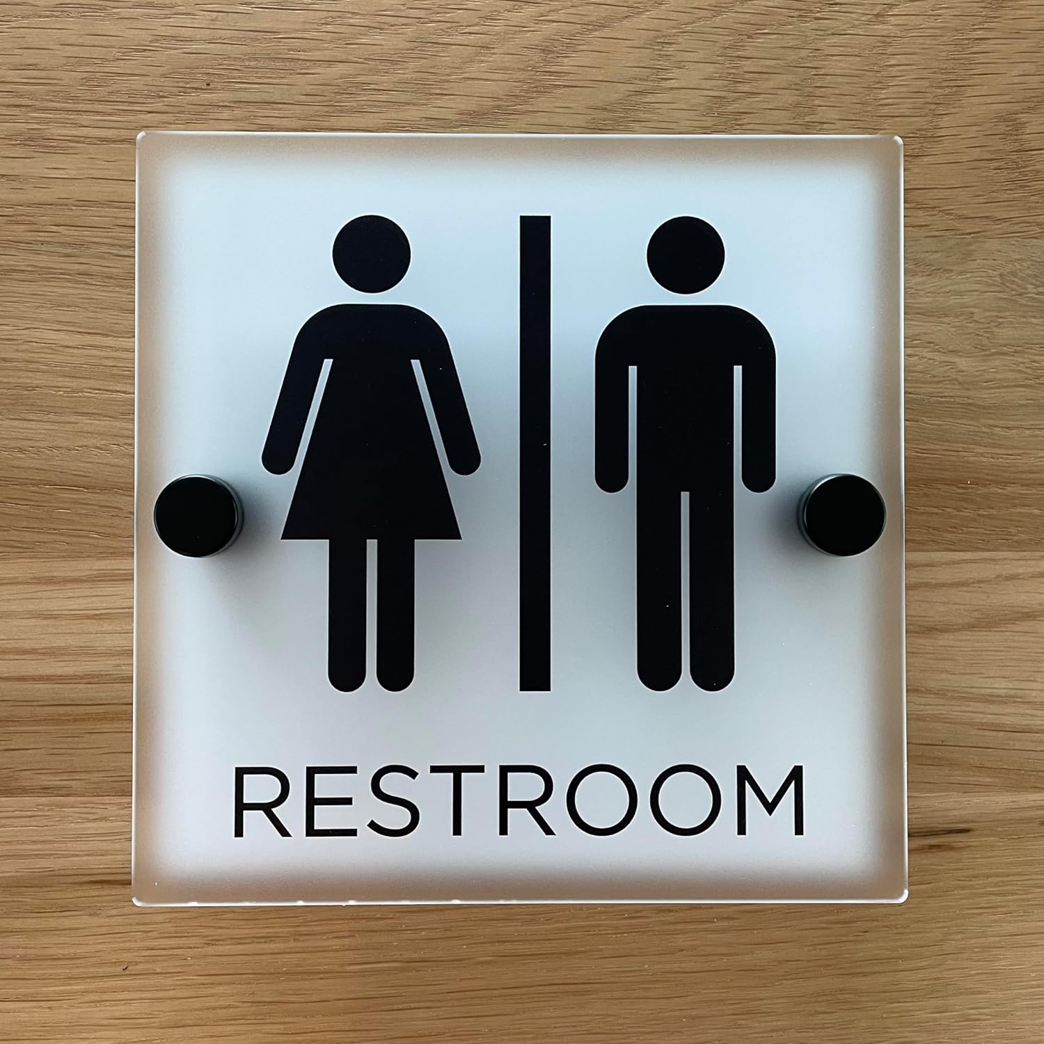 Restroom sign, matte acrylic with stainless steel mounting hardware (7" x 7" man/woman with word "RESTROOM", NO braille)