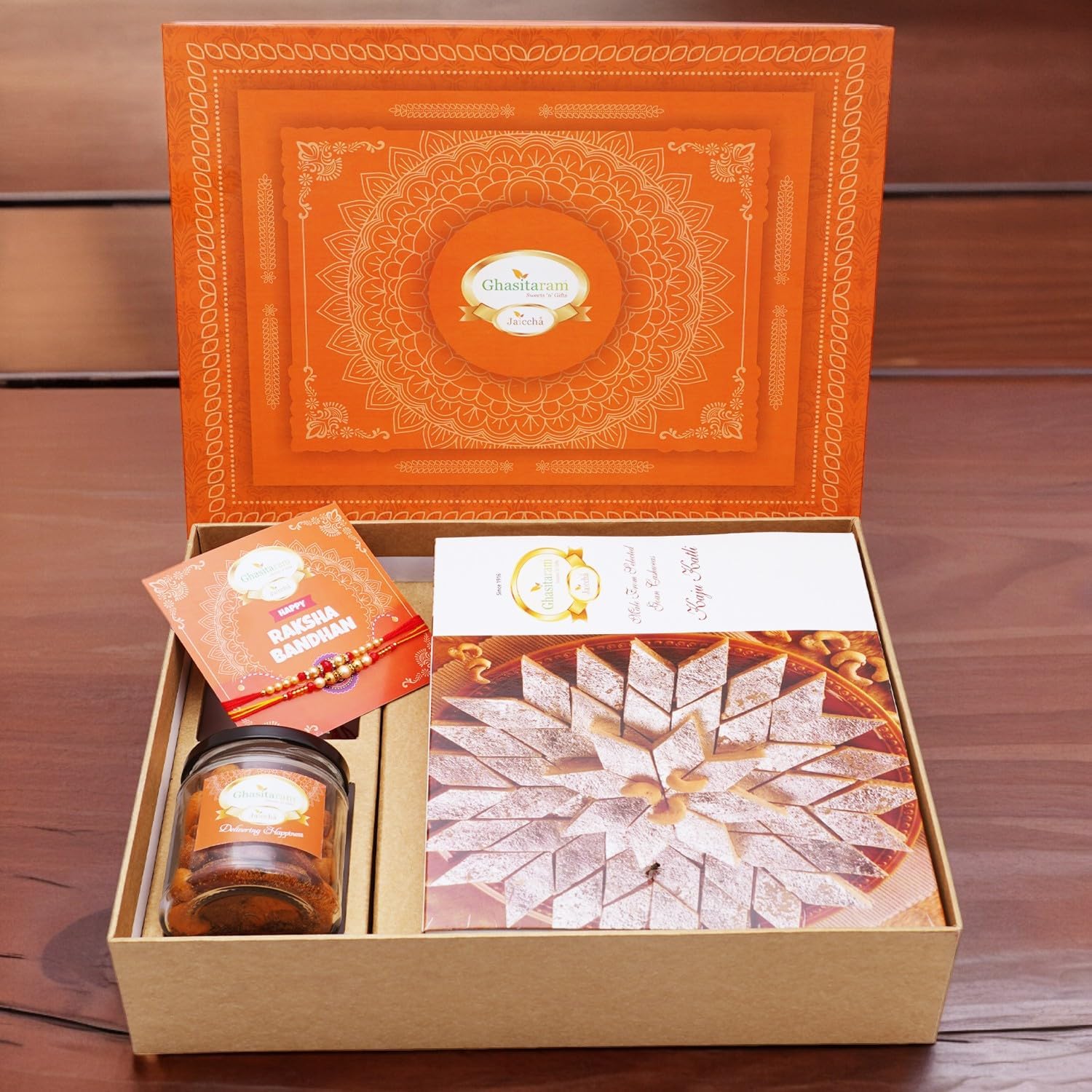 Ghasitaram Gifts Jaiccha Rakhi Gifts for Brothers Orange Hamper Box with Kaju Katli, 2 Rakhis, Card, and Mixed Dryfruit Jar